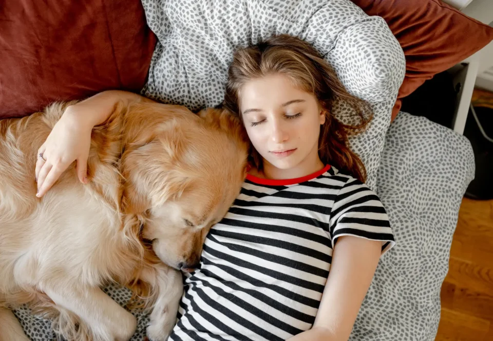 Girl sleeping with dog