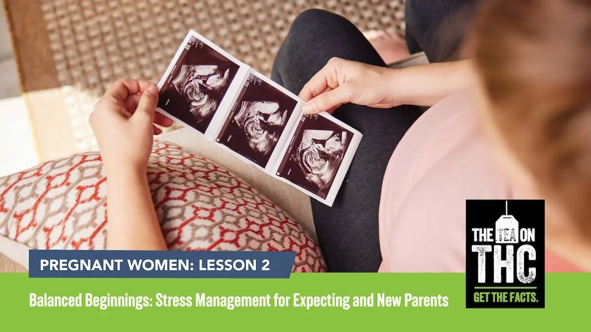 Camera pointing down at a pregnant woman looking at ultrasound pictures